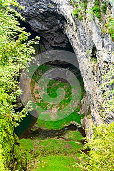 Macocha Abyss - large limestone gorge in Moravian Karst, Czech: Moravsky Kras, Czech Republic. View from the top - lower