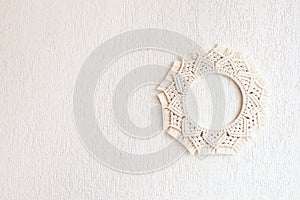 Macrame mandala. Macrame wreathe on a white background. Natural cotton thread. Eco home decor.  Copy space
