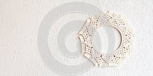 Macrame mandala. Macrame wreathe on a white background. Natural cotton thread. Eco home decor.  Panorama format for site banner,