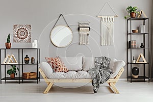 Macrame, mirror and ethno graphic on beige wall