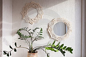 Macrame mirror and wreath on a white wall.  Eco-style. Natural materials
