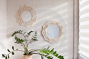 Macrame mirror and wreath on a white wall.  Eco-style. Natural materials