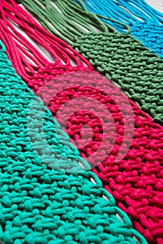 Macrame technique, a square knot of multi-colored threads.