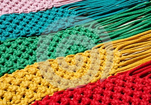 Macrame technique, a square knot of multi-colored threads