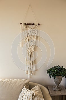 Macrame wall art in beige interior