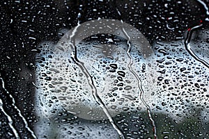 Macro abstract view of the water drops on a car windshield