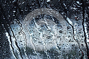 Macro abstract view of the water drops on a car windshield