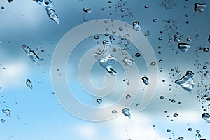 Macro abstract view of the water drops on a car windshield