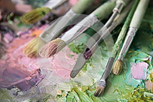 Macro artist`s palette, texture mixed oil paints in different co