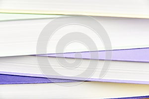 Macro background, front view of a pile of misaligned books filling the frame