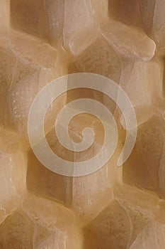 Macro background with an old sheet of natural beeswax sheet of comb foundation with a hexagonal pattern Cera Alba photo