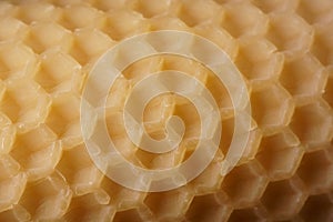 Macro background with an old sheet of natural beeswax sheet of comb foundation with a hexagonal pattern Cera Alba photo