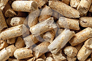 Macro background of wooden pellets. Compacted sawdust granules texture. Compressed sawdust as ecological biofuel. Alternative