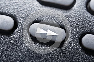 Macro Of A Black Fast Forward Button On Black Remote Control For A Hifi Stereo Audio System