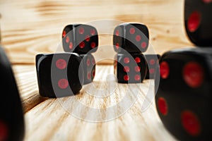 Macro of black tossed dice on wooden background