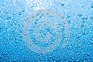 Macro of blue air bubbles in water
