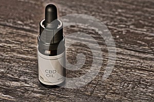 Macro of a bottle of cannabidiol -CBD- oil on a wooden background