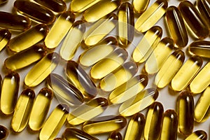 Macro of a bunch of yellow gel pills.