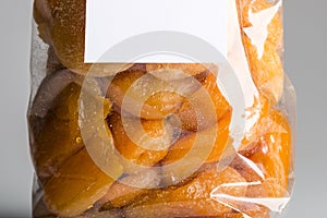 Macro of candied apricots in luxury plastic bag