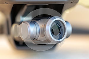 Macro close-up of a 3 axis electronic stabilized digital camera gimbal mounted on a modern remote controlled quadcopter drone. photo