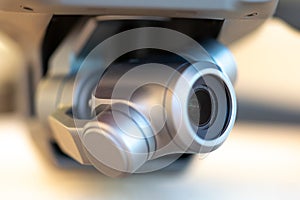 Macro close-up of a 3 axis electronic stabilized digital camera gimbal mounted on a modern remote controlled quadcopter drone. photo