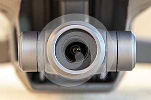 Macro close-up of a 3 axis electronic stabilized digital camera gimbal mounted on a modern remote controlled quadcopter drone. photo
