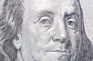 Macro close up of Ben Franklin's face on the US $100 dollar bill