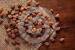 Macro Close-up of chana or chickpea Cicer arietinum or whole white Bengal gram dal cleaned on Jute mat and wooden