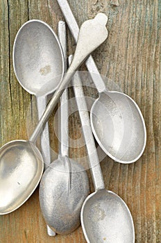 Macro close up detail of tarnished silver spoon handle and pewtr spoon