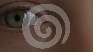 Macro Close-up eye blinking. Young girl is opening and closing herblond hair in school uniform. Boy and girl preschoolers on wind.