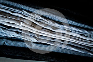 macro close-up of folded pants fabric jeans khakis on a surface clothing fashion background photo