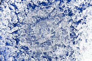 Macro close up of ice crystals on a blue background