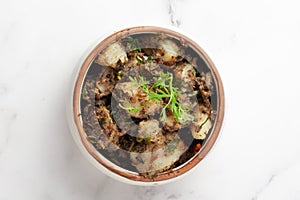 Macro Close-up of Indian vegetarian classic dish Jeera Aloo - Potatoes Flavored with Cumin  garnished with green coriander fresh