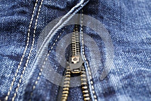 Macro close up of  blue casual denim jeans pants with metal teeth zipper