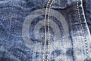 Macro close up of  blue casual denim jeans pants zipper compartment with yellow stitches focus on centre