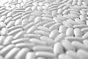 Macro close-up of many white pills, medication concept