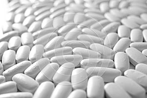 Macro close-up of many white pills, medication concept