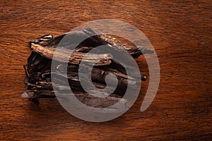 Macro close-up of Organic Alkanna tinctoria or ratan jot on wooden top background. Pile of Indian Aromatic Spice. photo