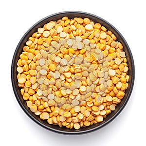 Macro Close-up of Organic Bengal Gram Cicer arietinum or split yellow chana dal on a ceramic black bowl.