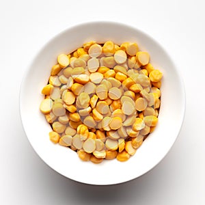 Macro Close-up of Organic Bengal Gram Cicer arietinum or split yellow chana dal inside a ceramic white bowl.