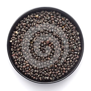 Macro Close-up of Organic Black Gram Vigna mungo or whole black urad on a ceramic black bowl.