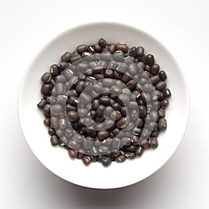 Macro Close-up of Organic Black Gram Vigna mungo or whole black urad inside a ceramic white bowl. photo