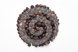 Macro close-up of Organic Black pepper Piper nigrum on white background. Pile of Indian Aromatic Spice.