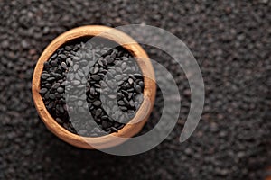 Macro Close-Up of Organic Black Sesame seeds Sesamum indicum or Black Til with shell in an earthen clay pot kulhar photo