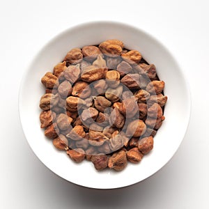 Macro Close-up of Organic chana or chickpea Cicer arietinum or whole white Bengal gram dal inside a ceramic white bowl.