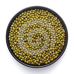 Macro Close-up of Organic green Gram Vigna radiata or whole green moong dal on a ceramic black bowl.