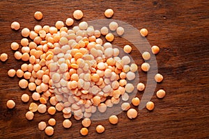 Macro Close-up of Organic masoor dal Lens culinaris or whole pink dal cleaned on wooden top background