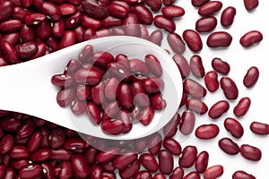 Macro Close-up of Organic Rajma,  Laal Lobia  or red kidney beans dal on a white ceramic soup spoon. Top view, over gradient