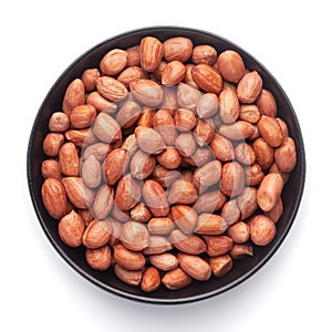 Macro Close up of organic red brown peanuts Arachis hypogaea on a black Ceramic bowl,