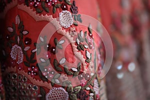 Macro close up of peach lehenga with intricate embroidery